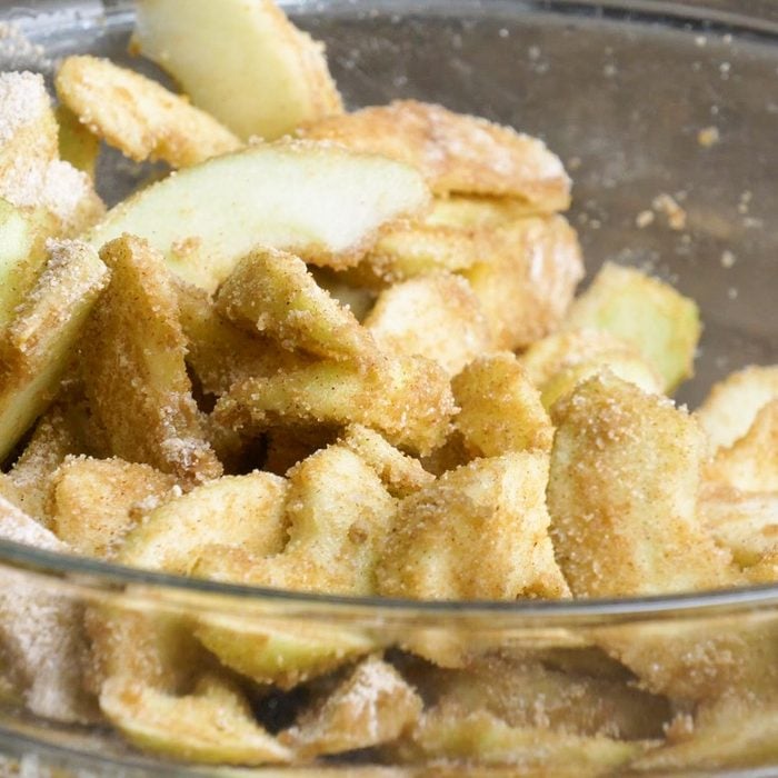 close up of apple pie filling mixture in a glass bowl