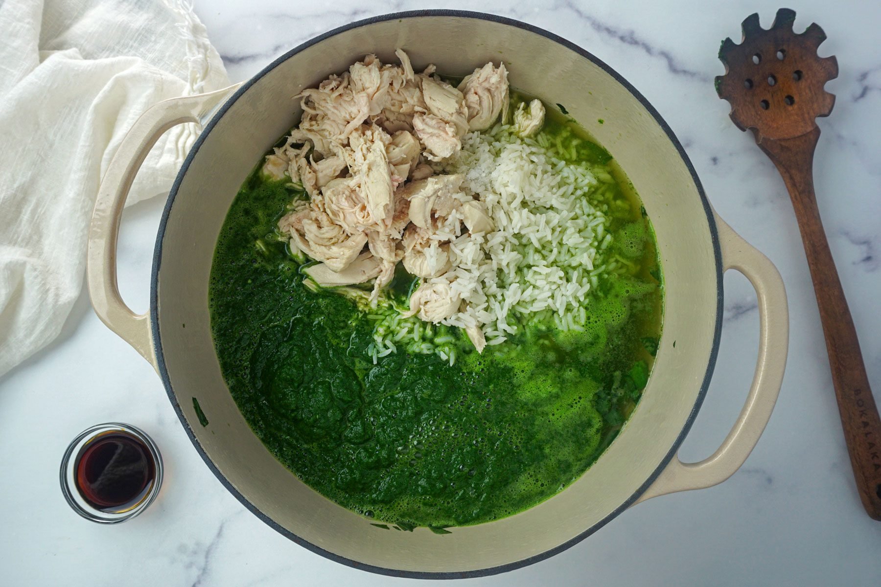 Spinach chicken soy sauce mixed in a pot